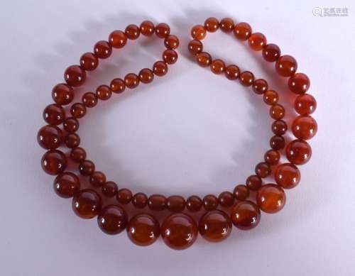 A GRADUATED AMBER COLOURED BEAD NECKLACE. Length 74cm, weigh...