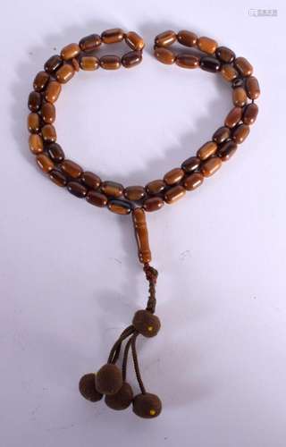 A STRING OF AMBER PRAYER BEADS. Length 68cm, weight 43g