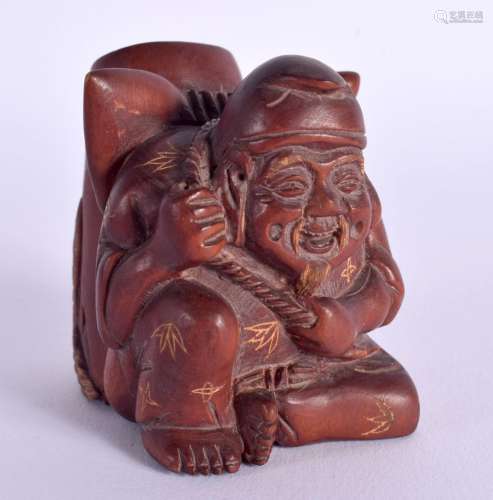 A JAPANESE CARVED WOOD PEN HOLDER IN THE FORM OF A SEATED MA...