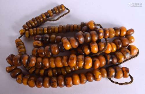 THREE MIDDLE EASTERN AMBER TYPE PRAYER NECKLACES. 716 grams....