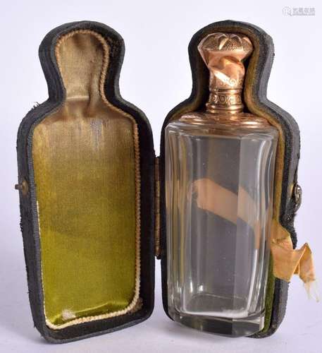 A GOLD TOPPED SCENT BOTTLE IN A FITTED CASE WITH VELVET LINI...