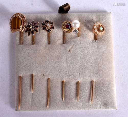 SIX ASSORTED JEWEL ENCRUSTED GOLD STICK PINS. 6.7cm long, to...