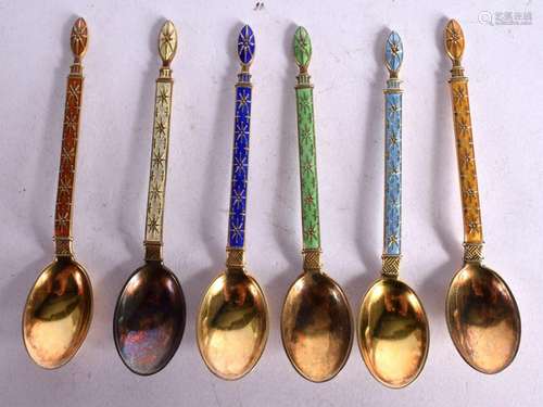 A SET OF SIX CONTINENTAL SILVER GILT AND ENAMEL COFFEE SPOON...