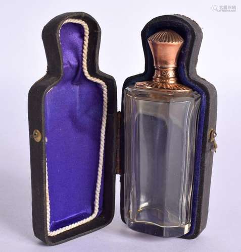 A GOLD TOPPED SCENT BOTTLE IN A FITTED CASE WITH VELVET LINI...