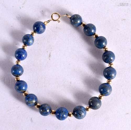 A 14CT GOLD AND LAPIS BRACELET. Stamped 14K, Bead size 7.4mm...