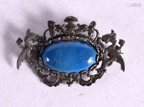 A SILVER BROOCH IN THE FORM OF TWO DRAGONS HOLDING A LAPIS O...