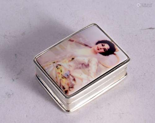 A STERLING SILVER PILL BOX WITH A LADY HOLDING A TENNIS RACK...