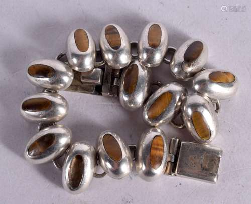 A SOUTH AMERICAN SILVER BRACELET WITH TIGERS EYE INSETS. Sta...