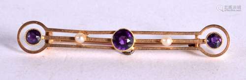 A 15CT GOLD BAR BROOCH INSET WITH PEARLS AND PURPLE GEMS. 5c...