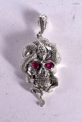 A SILVER SKULL AND SNAKE PENDANT WITH GEM SET EYES. 5.7cm x ...