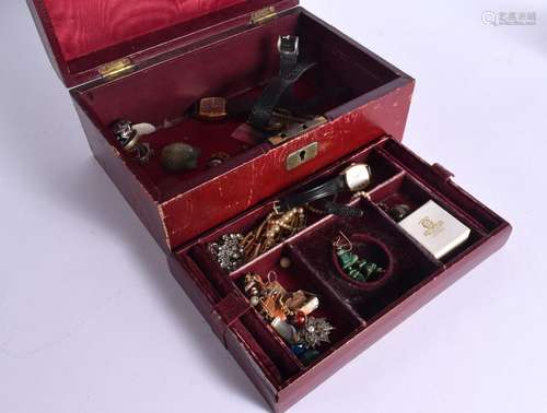 A RED LEATHER BOUND JEWELLERY BOX WITH COSTUME JEWELLERY. (q...