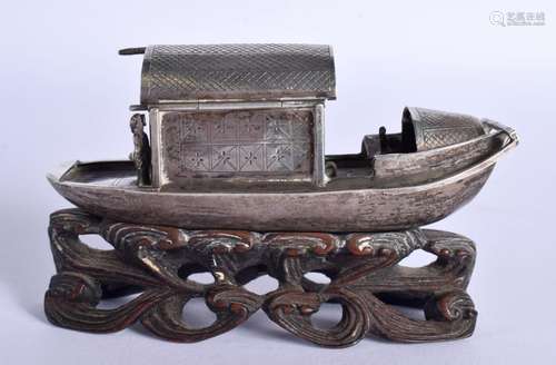 A CHINESE WHITE METAL MODEL OF A JUNK ON A HARDWOOD STAND. 9...