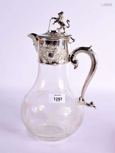 A ETCHED GLASS CLARET JUG WITH SILVER PLATED MOUNTS IN THE F...