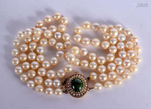 A PEARL NECKLACE WITH A 14CT GOLD AND JADE CLASP. Stamped 14...