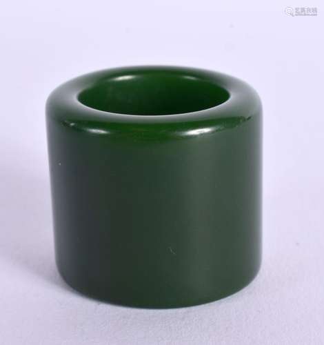 A GREEN JADE ARCHERS RING. 3.4cm x 3cm