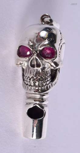 A CONTINENTAL SILVER SKULL PENDANT WITH GEM SET EYES. Stampe...