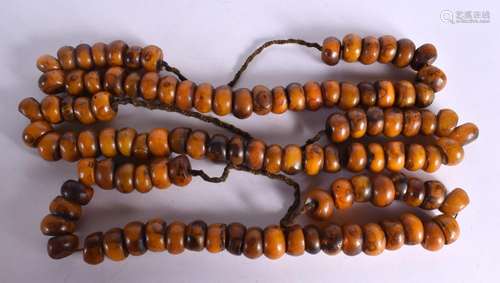 THREE LARGE MIDDLE EASTERN CARVED AMBER TYPE PRAYER NECKLACE...