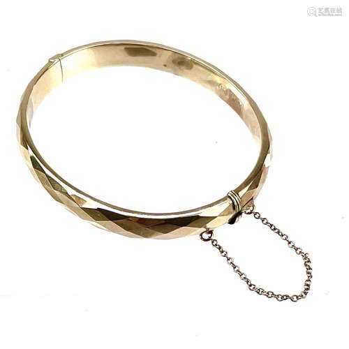 A continental yellow metal hollow hinged bangle.