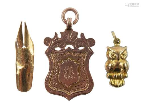 A 9ct rose gold shield fob, a 9ct gold owl charm and a 14ct ...