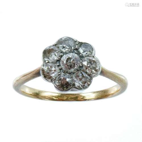 An 18ct gold and platinum diamond eight stone daisy ring.