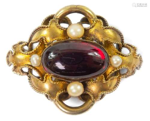 A Victorian gold carbuncle brooch.