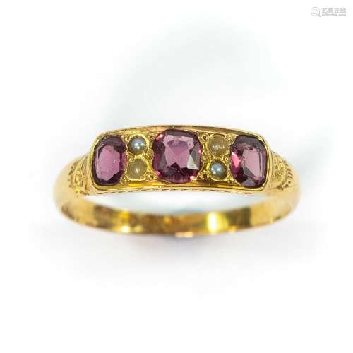 An early 20th century 15ct garnet and seed pearl set ring, B...