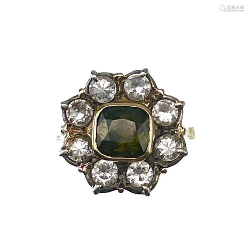 An 18ct white sapphire and green garnet set ring,