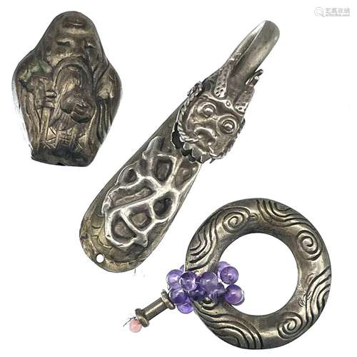 A Chinese white metal dragon head belt hook, width 6.5cm, an...