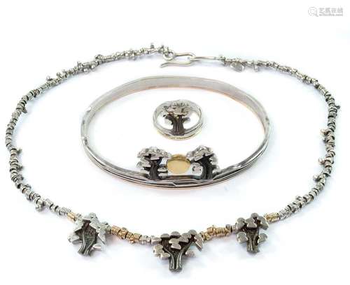 A contemporary silver and gold bracelet, ring and necklace.