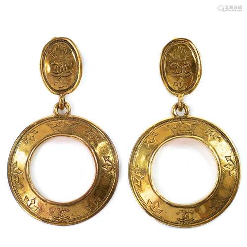 A pair of Chanel gold plated hoop earrings, with logo design...