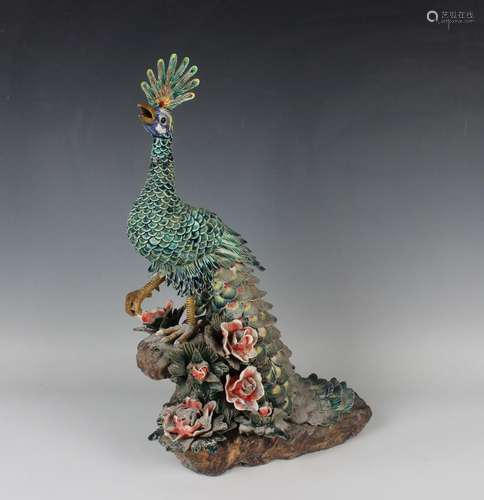 A Chinese pottery model of a peacock