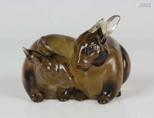 A Chinese pale brown glass figure group of two rabbits