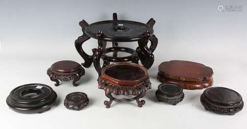 A collection of eight Chinese and Japanese wood stands