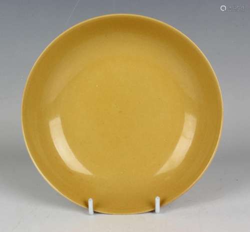 A Chinese yellow glazed porcelain circular saucer dish