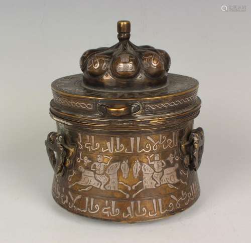 An Islamic silver inlaid brown patinated bronze inkwell and ...