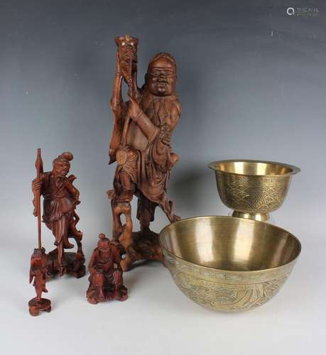 A Chinese carved hardwood figure of Liu Hai and this three-l...