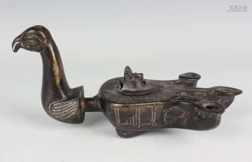 An Islamic silver inlaid brown patinated bronze bird-form oi...