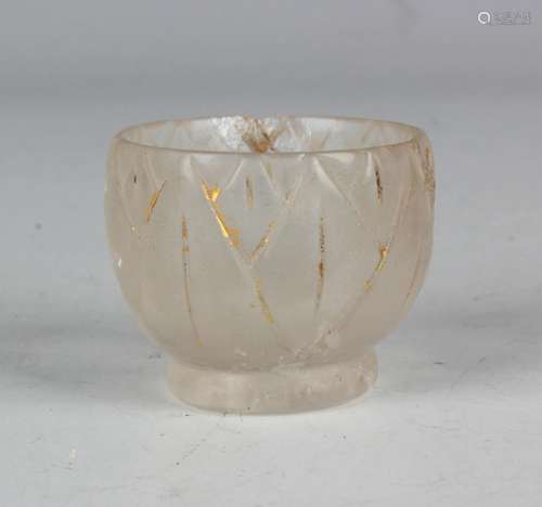 A rock crystal cup of circular form with carved leaf decorat...