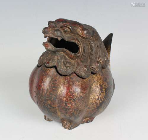 A Chinese red patinated gilt metal censer and cover in the f...