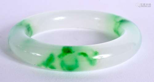 A CHINESE CARVED JADEITE BANGLE 20th Century. 7.25 cm diamet...