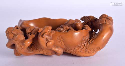 A JAPANESE CARVED BOXWOOD BRUSH WASHER overlaid with vines a...