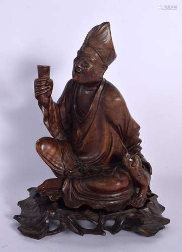 A 19TH CENTURY CHINESE CARVED HARDWOOD FIGURE OF A BUDDHA Qi...