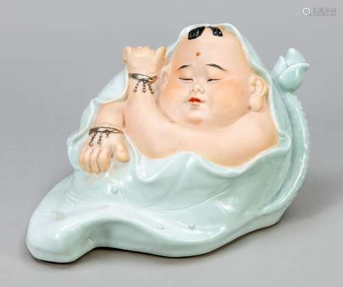 Porcelain figure of a baby in a lot