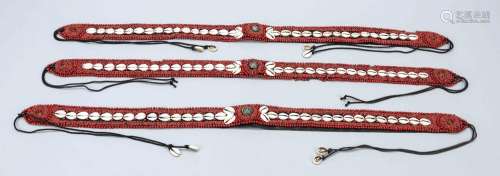 Three belts with beads and cowrie