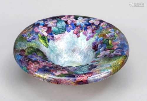 A bronze bowl with colourful flowe