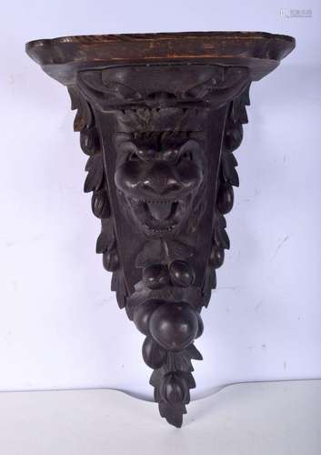 A late 19th Century carved wood lions head shelf. 53 x 30cm.