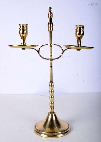 An antique adjustable brass candle stick. 37cm.