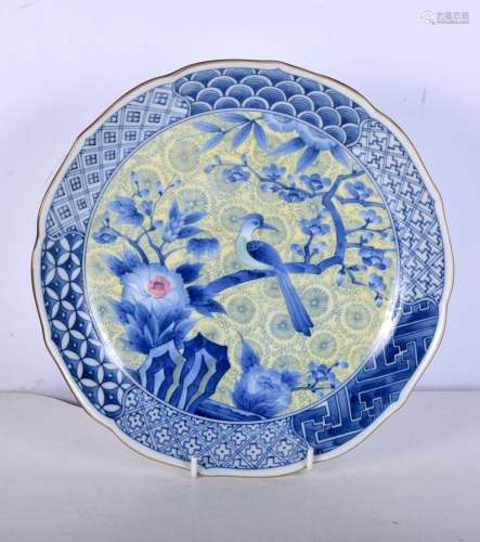 A Japanese porcelain plate decorated with a bird and foliage...