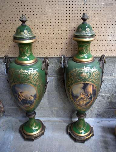 A pair of large continental vases with covers decorated with...