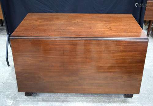 A large mahogany drop leaf table with eagle talon feet 74 x ...